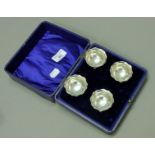 A cased set of four silver salts. Each 5 cm diameter. 80 grammes.