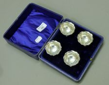 A cased set of four silver salts. Each 5 cm diameter. 80 grammes.