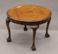 An early 20th century walnut coffee table. 60 cm diameter.