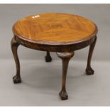 An early 20th century walnut coffee table. 60 cm diameter.