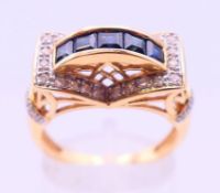 A 14 K gold, diamond and sapphire ring. Ring size R.