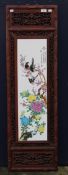 A Chinese plaque in a carved wooden frame. 36 x 120.5 cm.