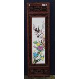 A Chinese plaque in a carved wooden frame. 36 x 120.5 cm.