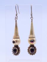 A pair of silver garnet drop earrings. 5 cm high.