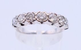 A 18 K white gold seven stone diamond ring. Ring size N.