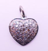 A diamond pendant in the form of a heart. 1.5 cm high.