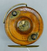 A circa 1900 Hardy wooden Nottingham reel with brass starback. 10 cm diameter.