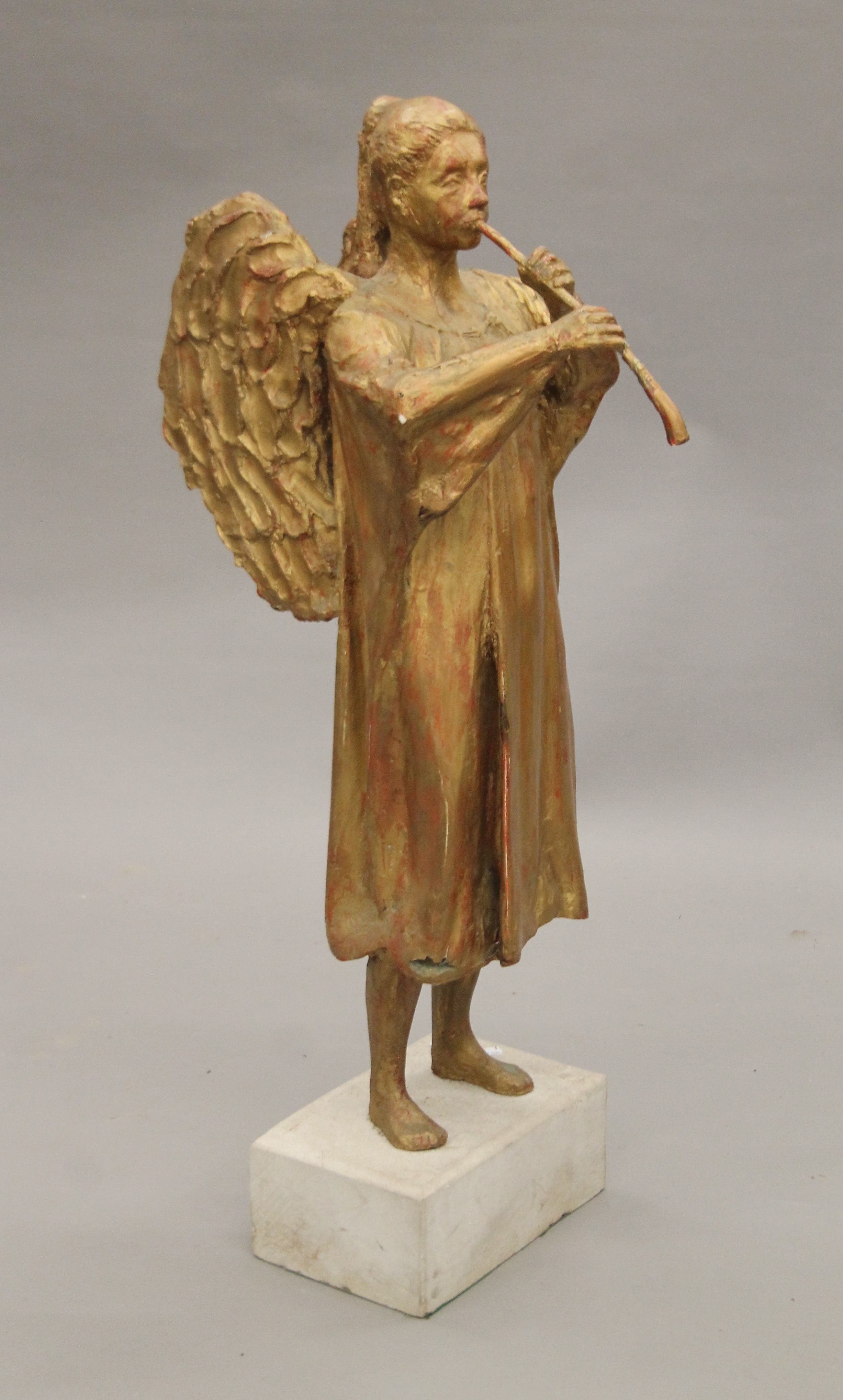 A gilt-painted sculpture of an angel mounted on a composite stone plinth base. 105 cm high. - Image 3 of 4