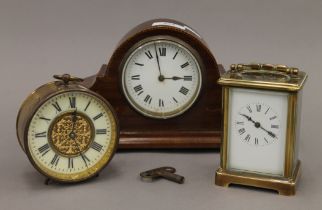 An Edwardian mantle clock, a carriage clock and a drum clock. The former 25.5 cm wide.