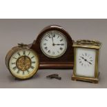 An Edwardian mantle clock, a carriage clock and a drum clock. The former 25.5 cm wide.