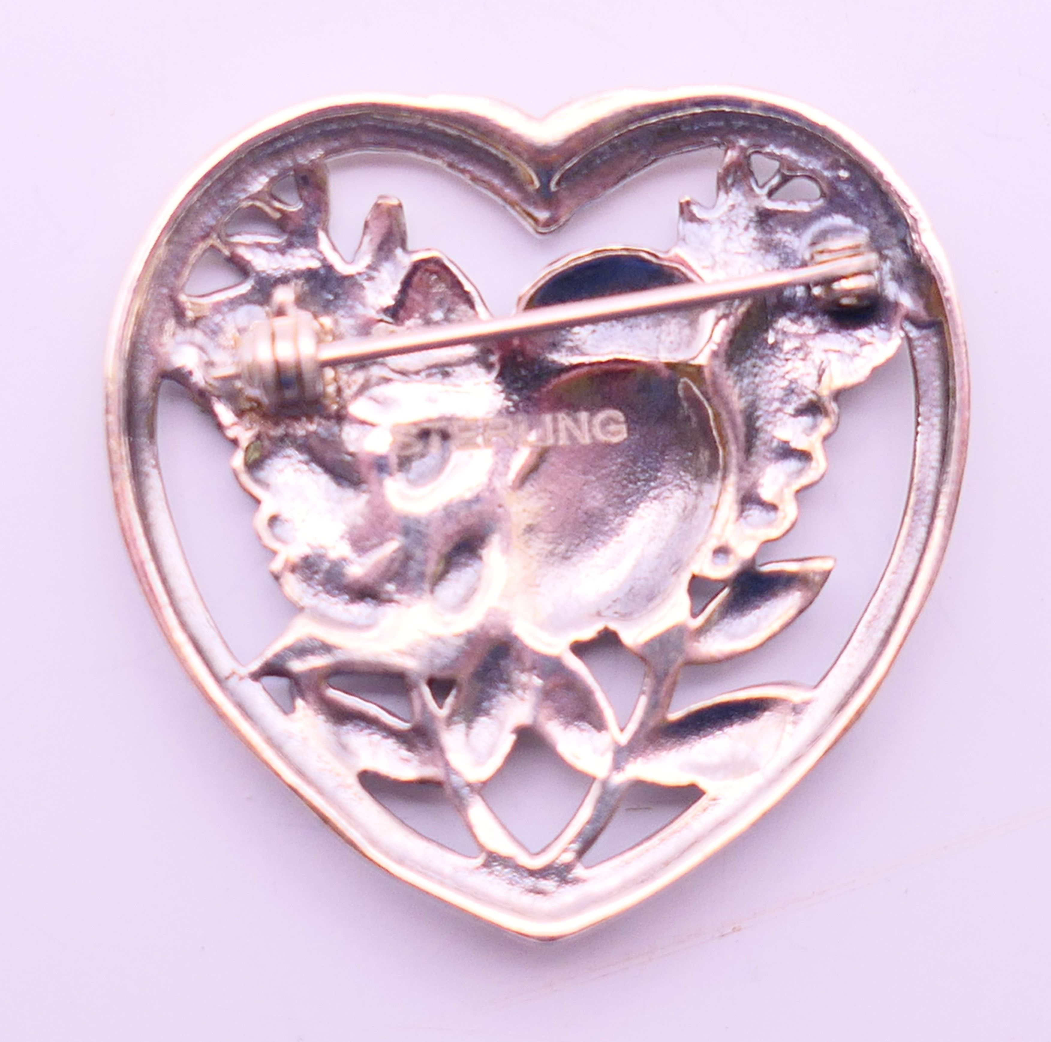 A silver brooch in the form of a bird within a heart. 3.25 cm high. - Image 3 of 4