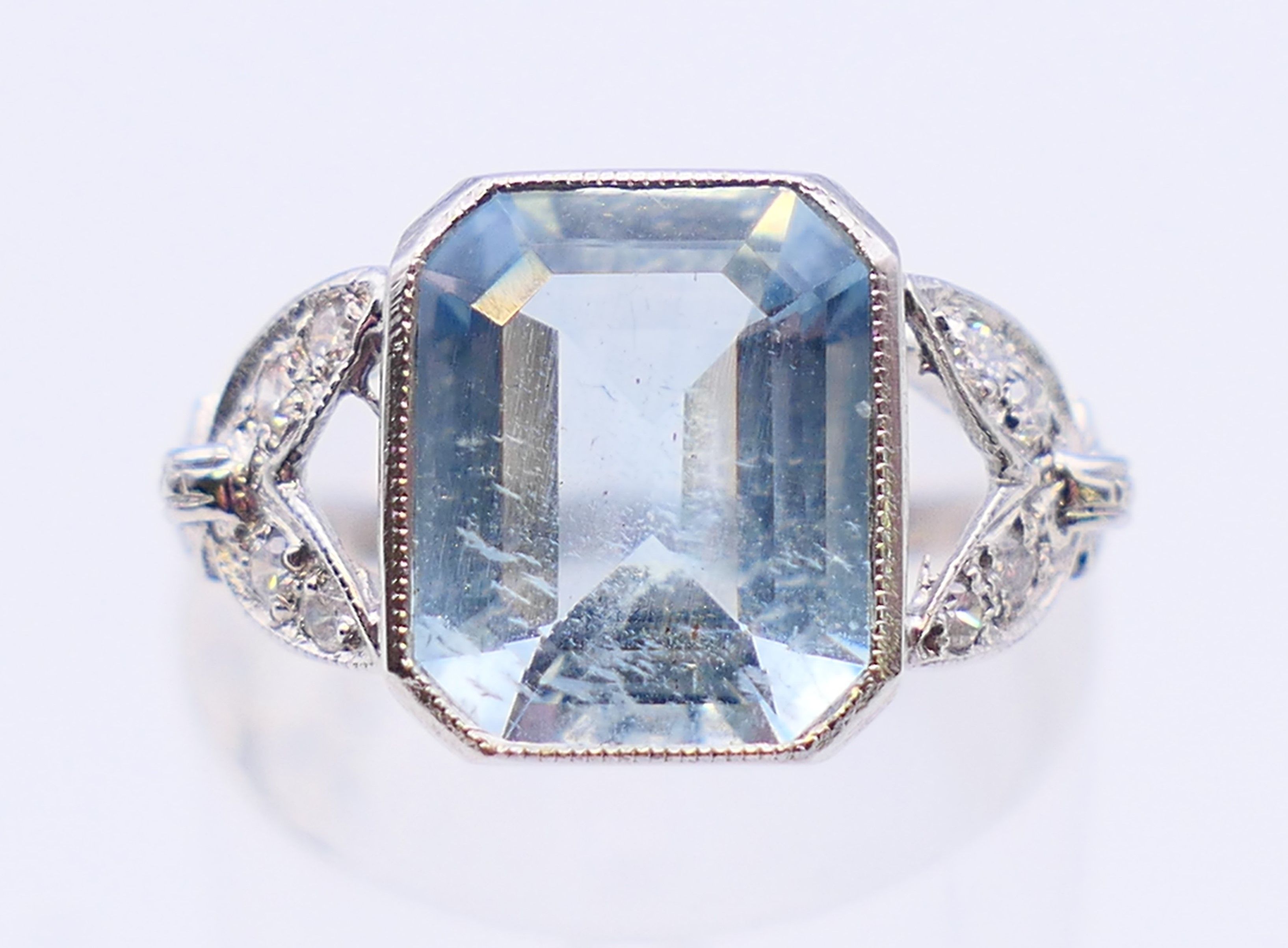 A platinum, aquamarine and diamond ring. Ring size L/M.