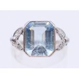 A platinum, aquamarine and diamond ring. Ring size L/M.