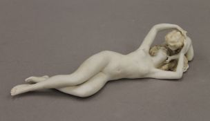 A 19th century Continental bisque porcelain figural group of a nude woman and a child. 24 cm long.