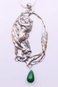 A silver and jade Art Nouveau style female figure pendant on a silver chain.