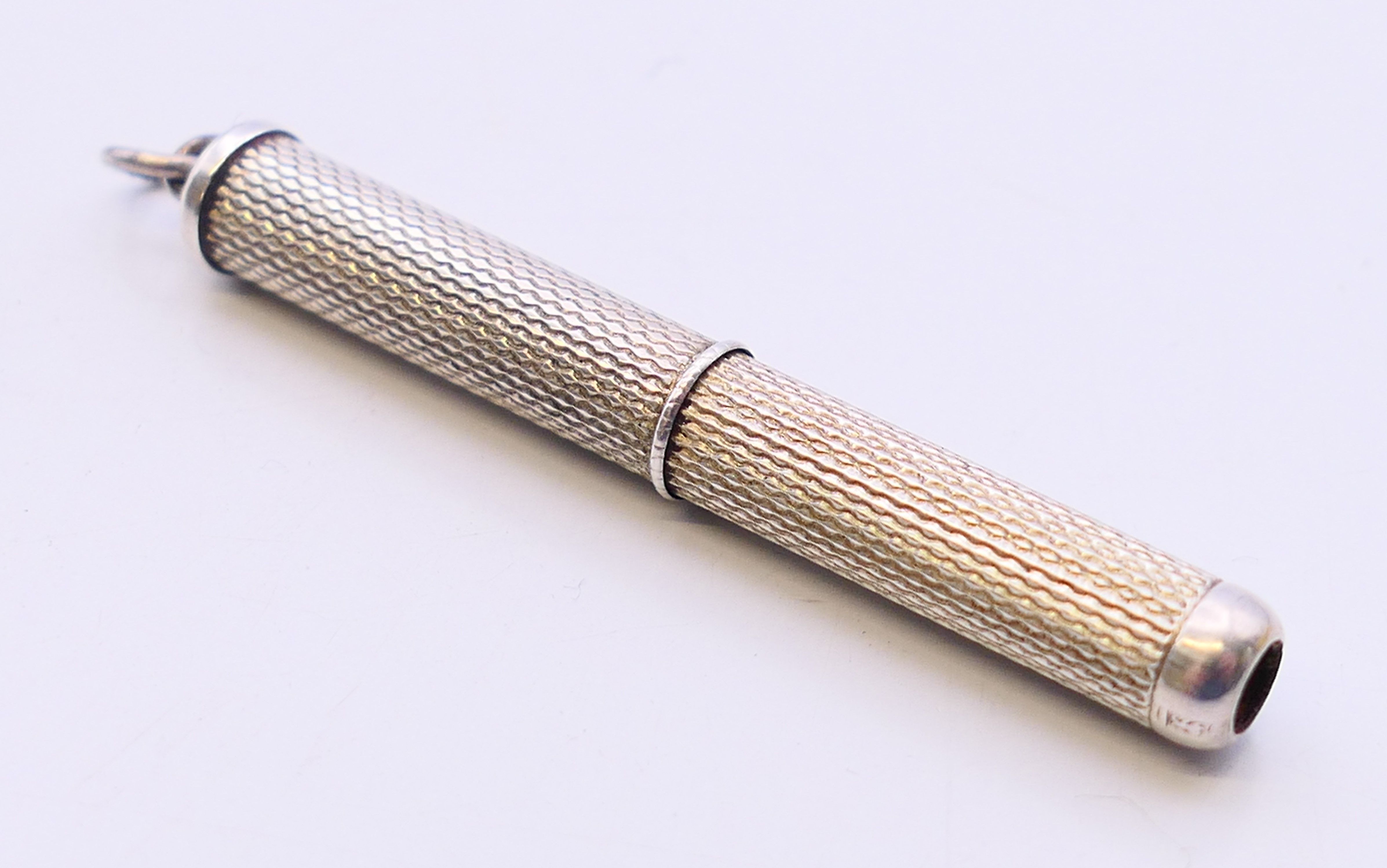 A silver toothpick. 4.5 cm long closed.