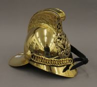 A replica brass fireman's helmet. 26.5 cm high.