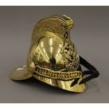 A replica brass fireman's helmet. 26.5 cm high.