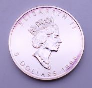 A 1998 Canadian fine silver one ounce 5 dollar maple leaf coin.