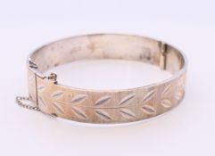 A Monomil silver bangle with inscription to inner band 'To my wife on our wedding day 6th April