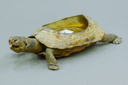 A taxidermy specimen of a tortoise formed as a coaster. 19.5 cm long.