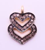 A diamond double heart charm/pendant. 1.5 cm high.