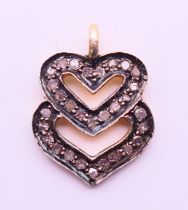 A diamond double heart charm/pendant. 1.5 cm high.