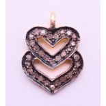 A diamond double heart charm/pendant. 1.5 cm high.