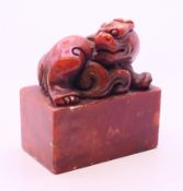 A rectangular dog-of-fo red hardstone seal. 5 cm high.