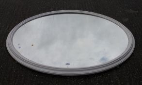 A large white painted Victorian oval mirror. 143 cm wide.