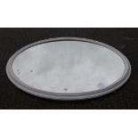 A large white painted Victorian oval mirror. 143 cm wide.