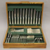 An oaked-cased silver-plated cutlery canteen. 49 cm wide.