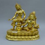 A gilt bronze figure of two deities. 29 cm high.