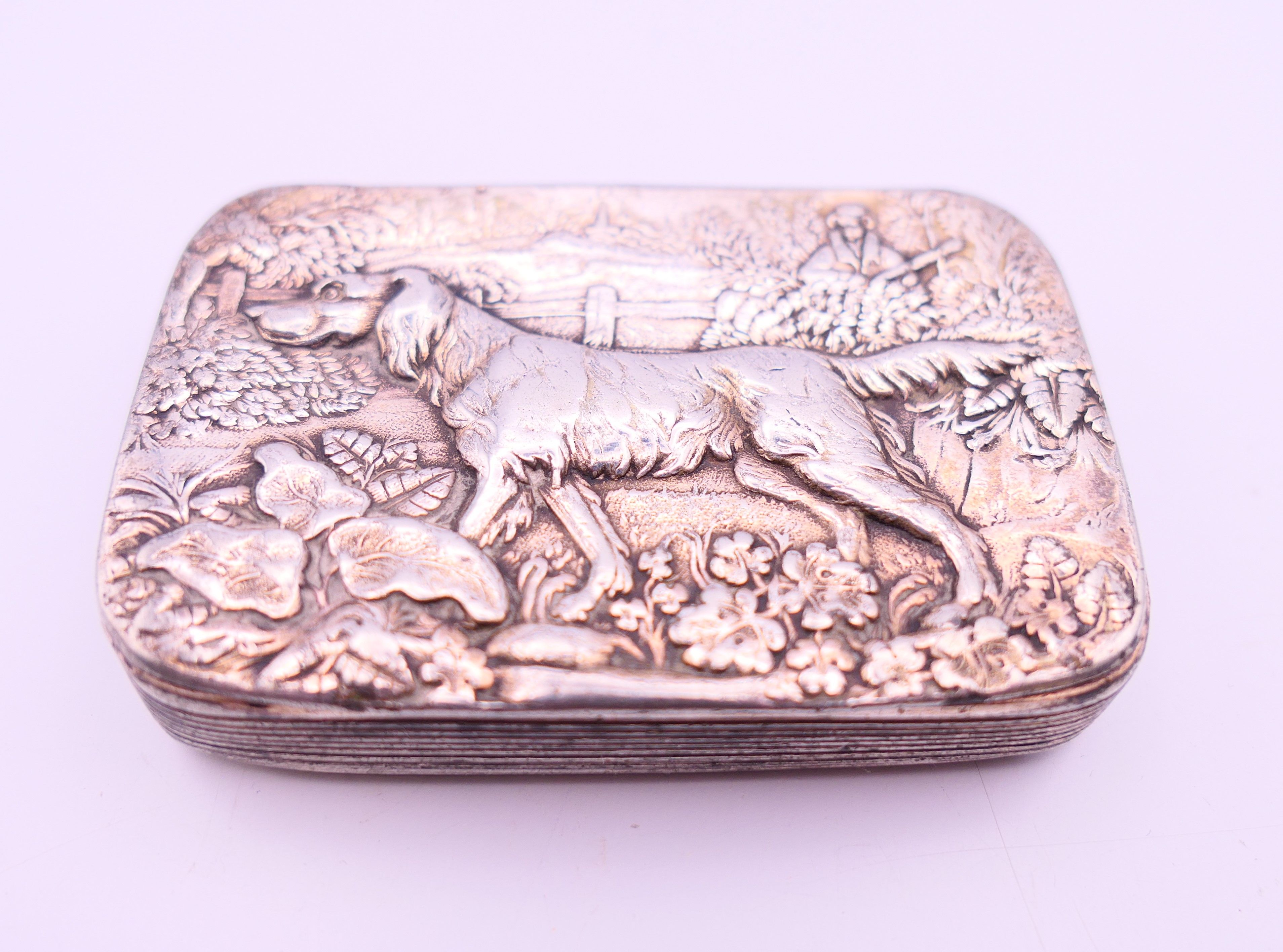 A Victorian silver plated snuff box embossed with a shooting scene with a flat coat retriever. 6.