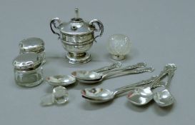 A small silver table lighter and three silver mounted jars and teaspoons. The former 6.5 cm high.