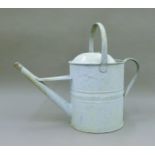 A vintage watering can. 43 cm high.