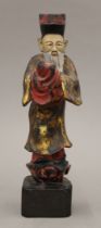 A Chinese painted carved wooden figure. 25.5 cm high.