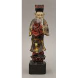 A Chinese painted carved wooden figure. 25.5 cm high.