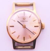 A 9 ct gold cased Omega ladies wristwatch. 2 cm diameter. 7.7 grammes total weight.