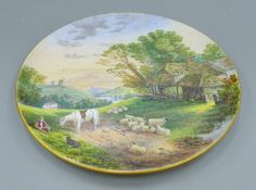A 19th century circular wall plaque by T T and Co, handpainted with rural scenery. 38 cm diameter.