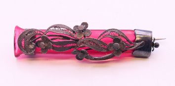 An unmarked white metal mounted cranberry glass posy holder. 7 cm long.