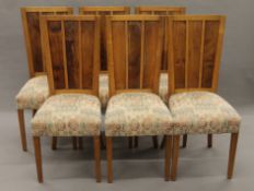 A set of six early 20th century oak and yewwood dining chairs. 45 cm wide.