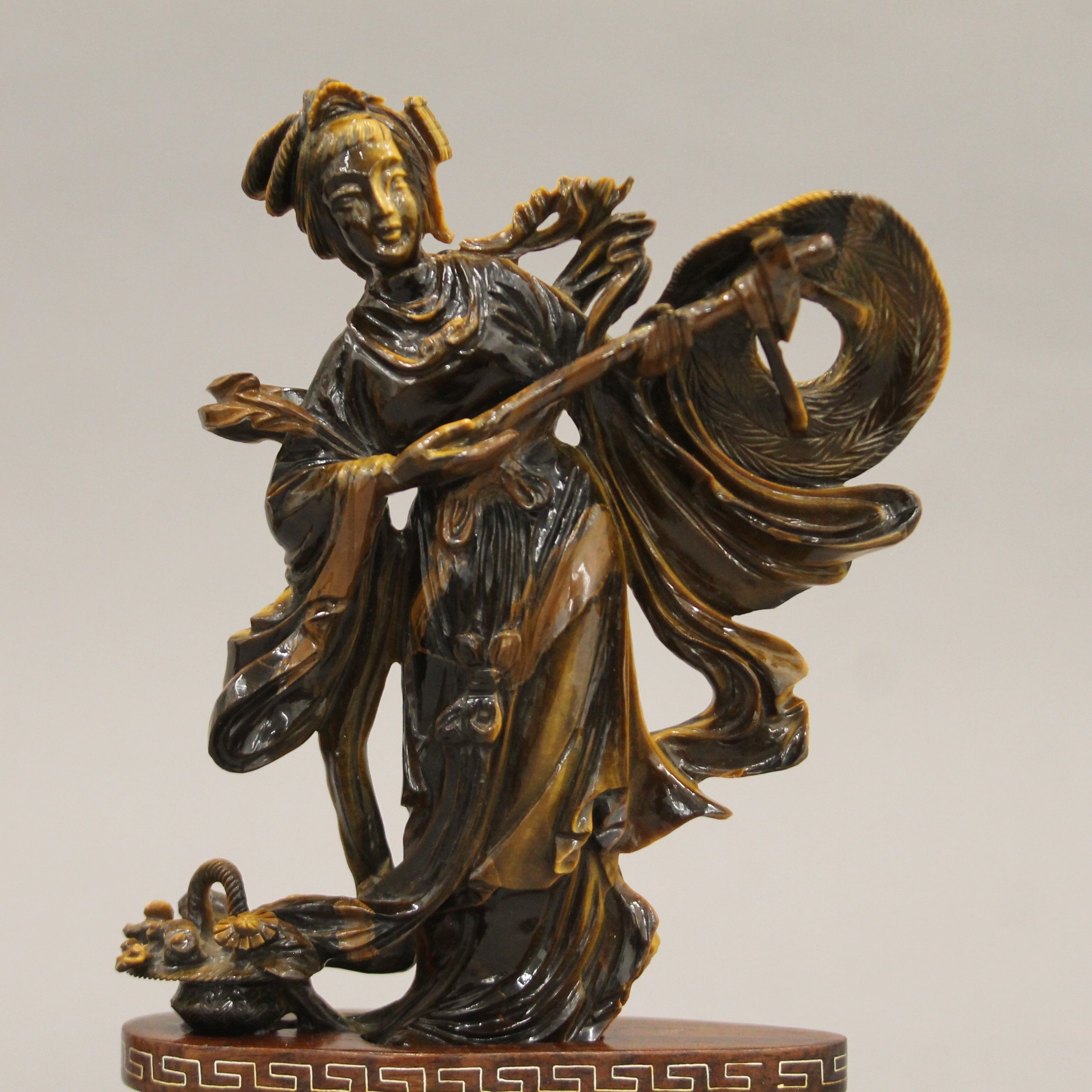 A Chinese tiger's eye hardstone carving of a maiden on a carved wood base. 18.5 cm high. - Image 2 of 5
