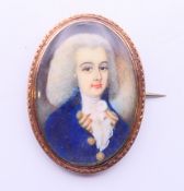 An 18th century miniature portrait on ivory of a young gentleman wearing a powdered wig set in a