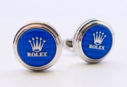 A pair of Rolex cufflinks with certificate. 2 cm diameter.