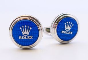 A pair of Rolex cufflinks with certificate. 2 cm diameter.