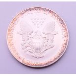 An American one ounce fine silver one dollar coin, cased.