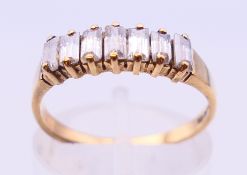A 9 ct gold baguette set ring. Ring size J/K.