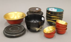 A quantity of Oriental items, including cloisonne bowls, papier mache bowls and two wooden stands.