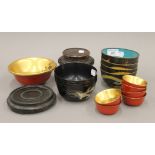 A quantity of Oriental items, including cloisonne bowls, papier mache bowls and two wooden stands.